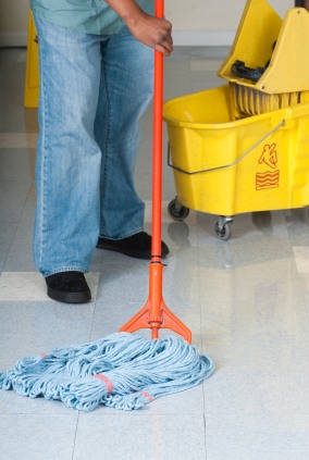 Above and Beyond Services LLC janitor in Kansas City, MO mopping floor.